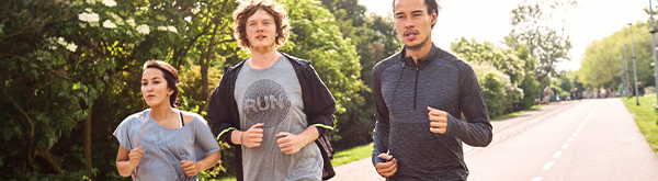 Three people jogging outside
